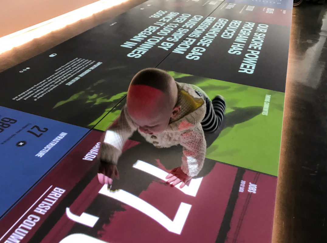 While Katie and Emily were on the Fly Over Canada ride, Chris watched the kids as they liked to crawl around on the light display. This is Colin.