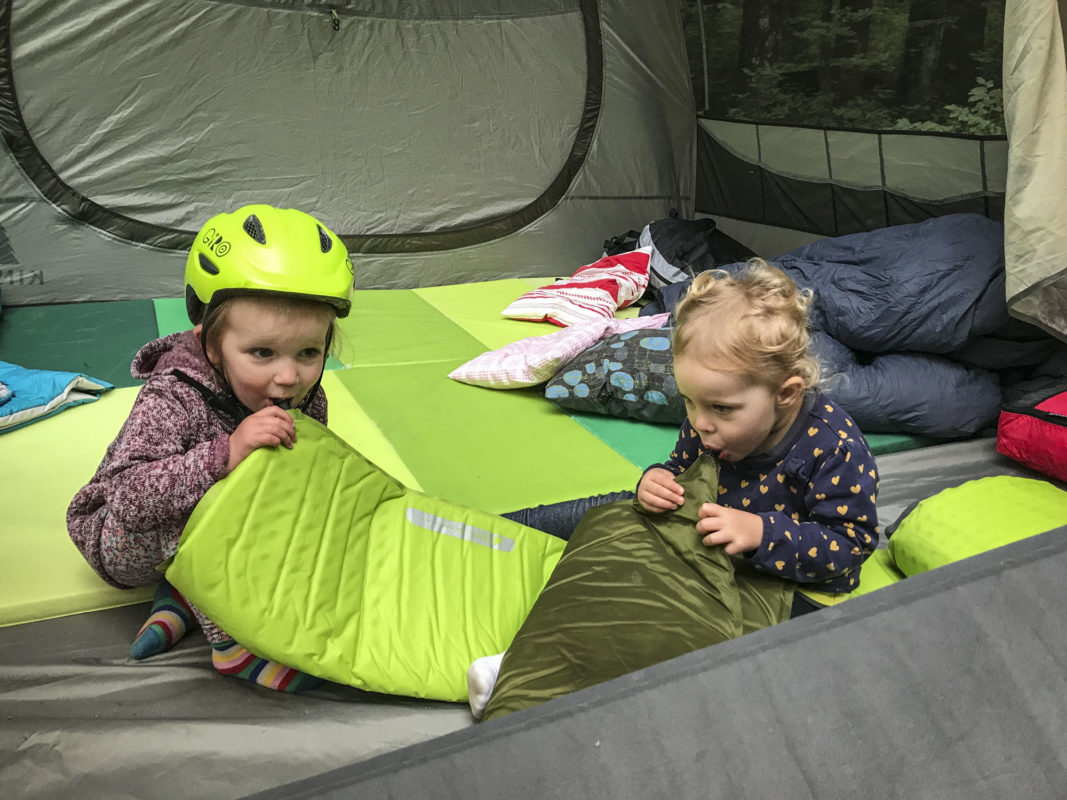 Evelyn and Addison blow up the air mattresses in the tent.