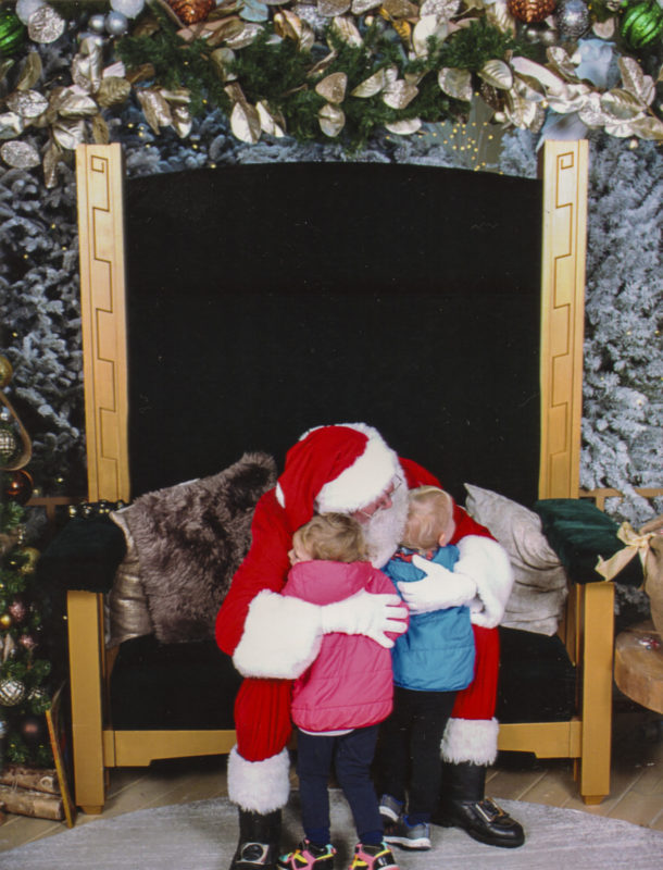 The first photo of them hugging Santa from a couple weeks ago.